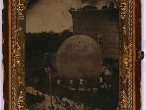 A daguerreotype image showing a large balloon being inflated.