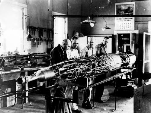Robert Goddard works on a rocket with his team. 