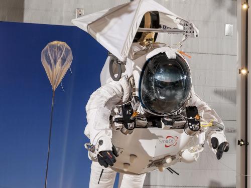 Front view of Alan Eustace's white freefall jumpsuit hanging on display in the Museum