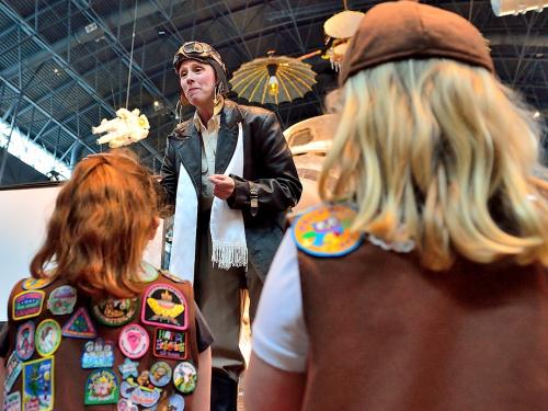 Costumed character talks to girls at family day event