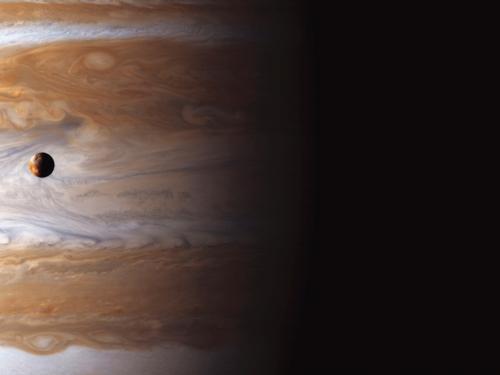 Io High Above Jupiter’s Storms