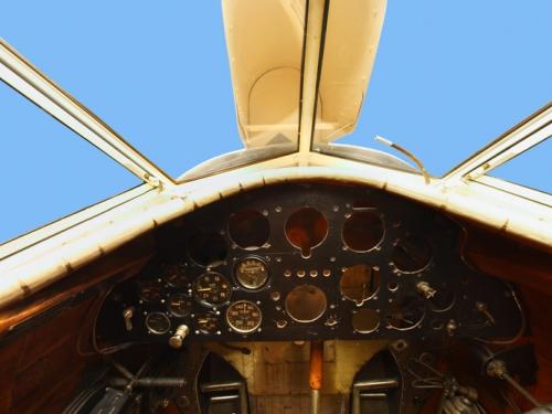 Panoramic photo of a Lockheed Vega wooden cockpit, missing some dials in control panel