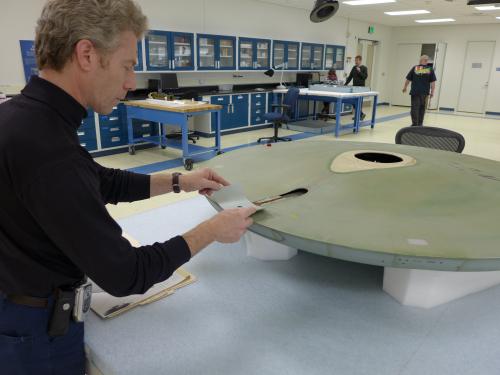 A Museum conservation specialist tries to find the correct paint color for a gray spaceship studio model used in the television series Star Trek