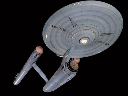 A studio model of the Starship Enterprise, a ship used in the Star Trek franchise with a saucer, two warp drives, and a cargo bay