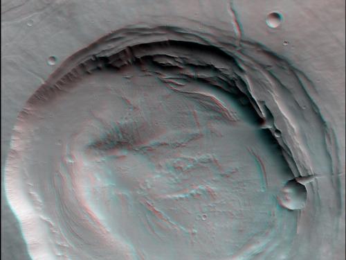 3-D anaglyph of a caldera, a collapsed area of land following a volcanic eruption, atop Biblis Patera, a volcano, on Mars.