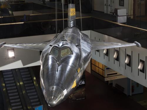 Tip of black titanium rocket-shaped North American x-15 aircraft hanging in museum