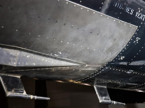 Metal plated vent on bottom of black titanium North American X-15 aircraft