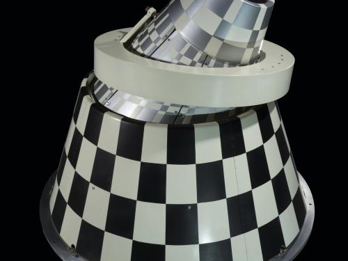 Infrared sensor with black and white checkered cone with a ring mount.