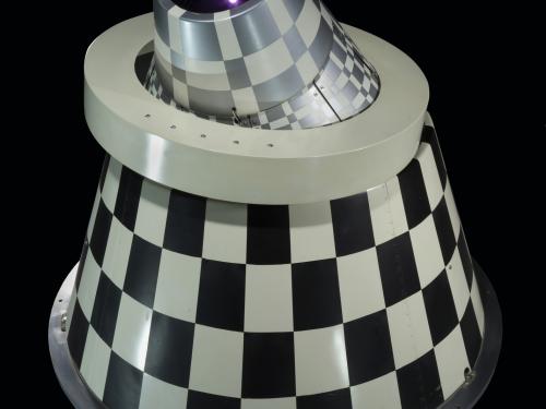 Rear view of an infrared sensor with black and white checkered cone with a ring mount.