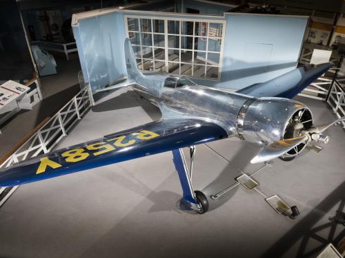 Top of metalic silver and blue Hughes H-1 Racer aircraft in museum