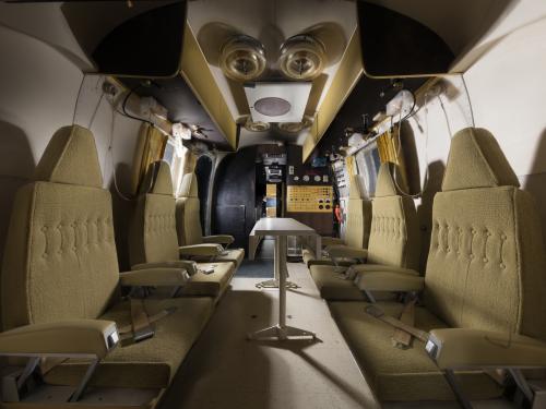 interior view of the Mobile Quarantine Facility, which includes six seats, six bunks, kitchen and bathroom.