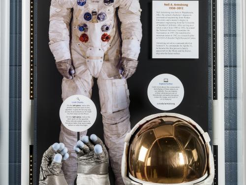 Wide view of Neil Armstrong's Apollo 11 gloves and helmet on display