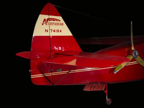 Red and tan painted vertical and horizontal stabilizer of the plane. Painted on the tan parts of the paint are Airphibian and N74154.