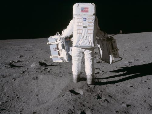 Buzz Aldrin carrying experiments on the surface of the Moon