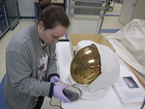Conservator uses a device on a helmet. 
