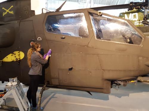 Conservator cleans the surface of a helicopter.