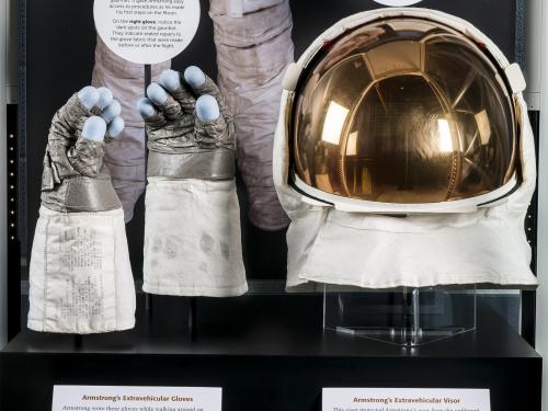 Close up view of Neil Armstrong's gloves and helmet from the Apollo 11 mission