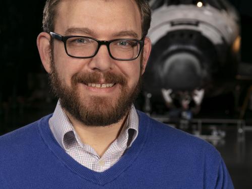 Professional portrait of a man in front of space shuttle