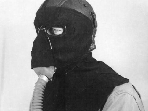 Member of the 390th Bomb Group, modeling a frostbite mask