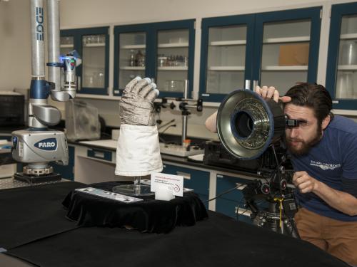 Armstrong glove on a stand while being 3D scanned.