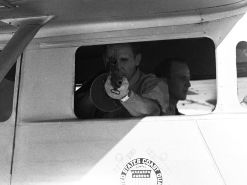 A photo of a Coast Guardsman during a demonstration on handling drug smuggling.