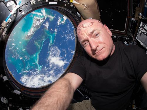 A photograph of Kelly with a view of the Earth in the background. 