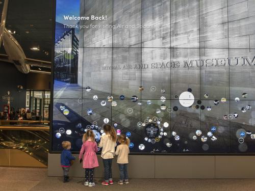 Children try out an interactive display in the Boeing Milestones of Flight Hall 