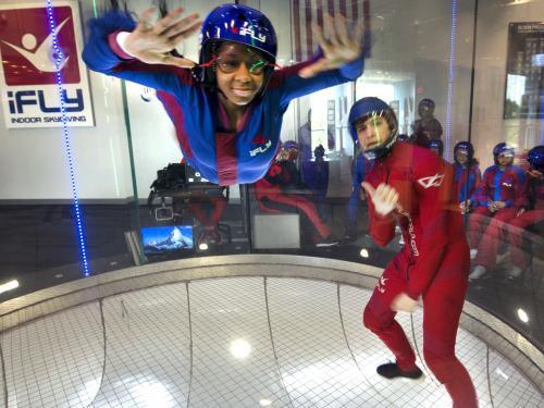 A student attending the "She Can" STEM camp goes indoor skydiving on a field trip to iFly in Ashburn, Virginia. 