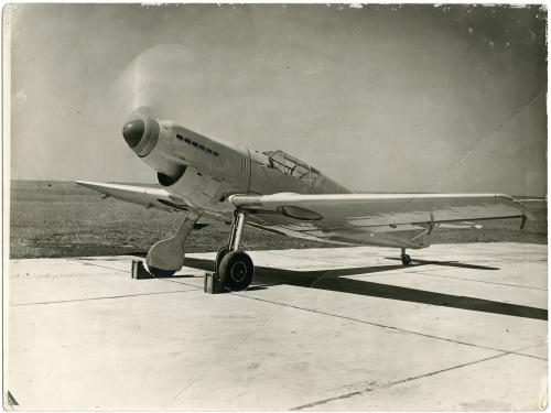 Messerschmitt on concrete with cholks on front wheels, nose facing the camera. 