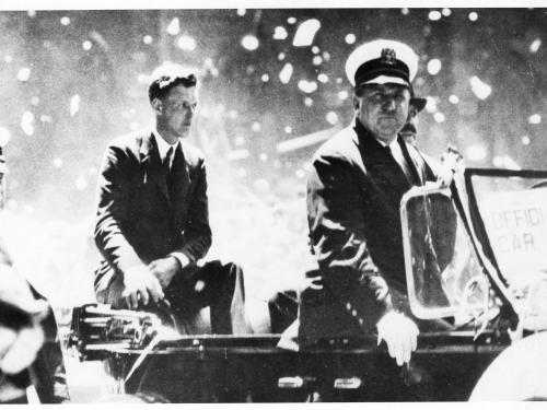 Informal portrait of Charles Lindbergh in a parade. 