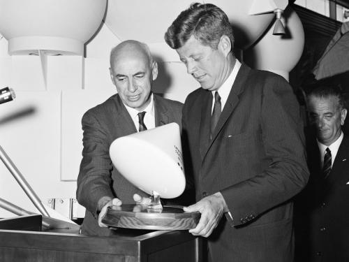 Man holding command module model with John Kennedy