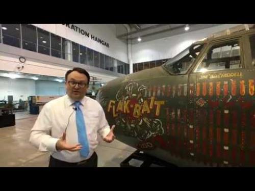 Video interview in front of a World War II aircraft discussing its restoration.