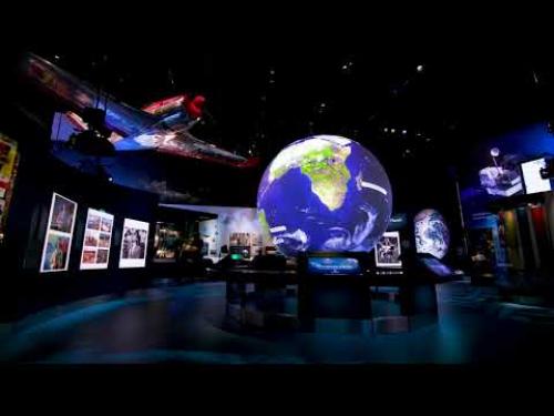 A video showing a fly through of the One World Connected exhibit which features a large interactive globe at its center.