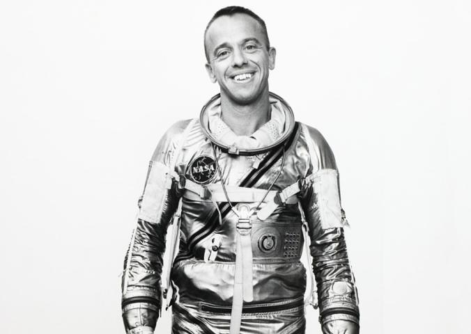 Alan Shepard, in his shiny Mercury spacesuit, smiles at the camera. 