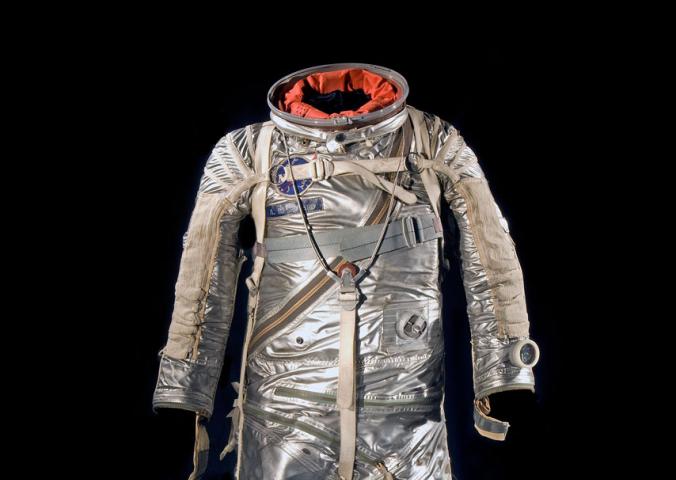 Silver-coated, full-body flight suit with various spots for tubes to be placed. 