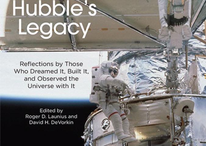 Book cover featuring a partial view of the Hubble Space Telescope in orbit as an astronaut performs a spacewalk next to the telescope. The book title "Hubble's Legacy" is placed on a solar panel that is perpendicular to the rest of the visible telescope.