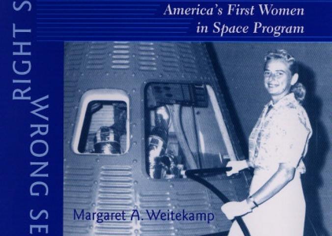 Scan of a book cover with a blue-colored photo of a female astronaut candidate standing beside a Mercury spacecraft.