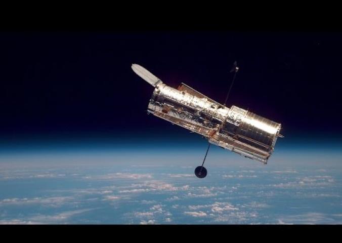 An interview with a Smithsonian curator about the repairs on the Hubble Space Telescope performed by astronauts soon after the launch of the telescope