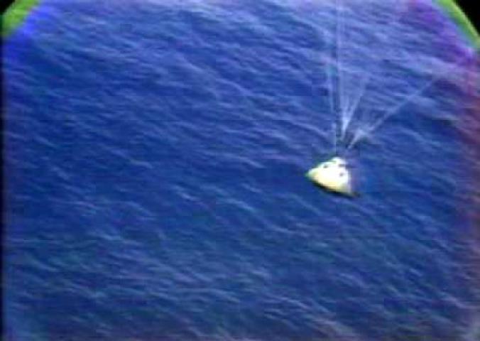 A video of the Apollo 15 Command Module splashing down into the ocean. Only 2 of the 3 parachutes open.