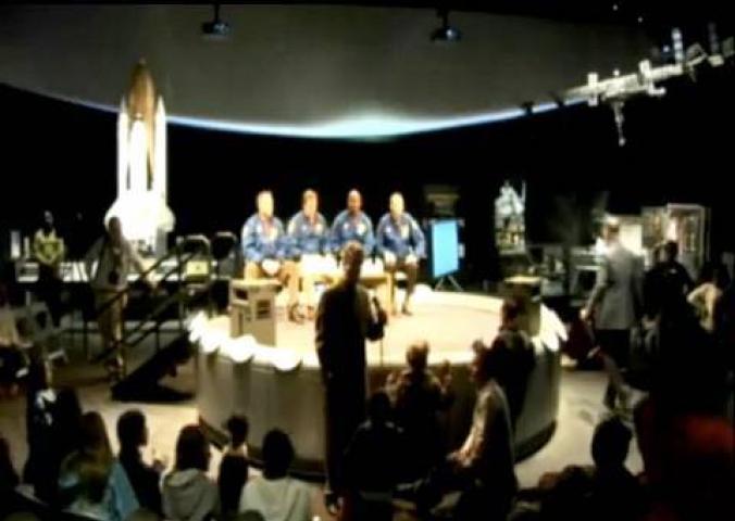Astronauts aboard the Space Shuttle STS-129 discuss their mission and then answer questions from an audience.