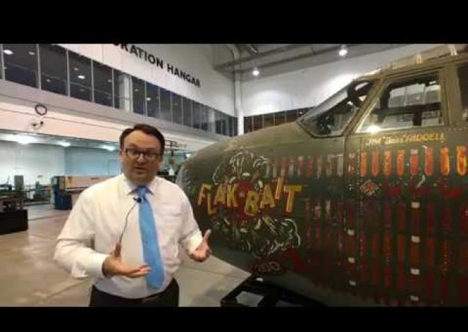 Video interview in front of a World War II aircraft discussing its restoration.
