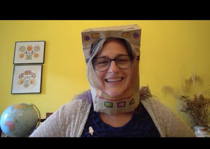 A video showing how to make a paper bag astronaut hat.