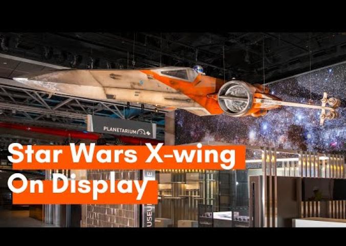 Video with behind-the-scenes footage of the X-wing being displayed.