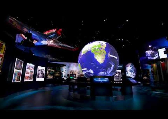 A video showing a fly through of the One World Connected exhibit which features a large interactive globe at its center.
