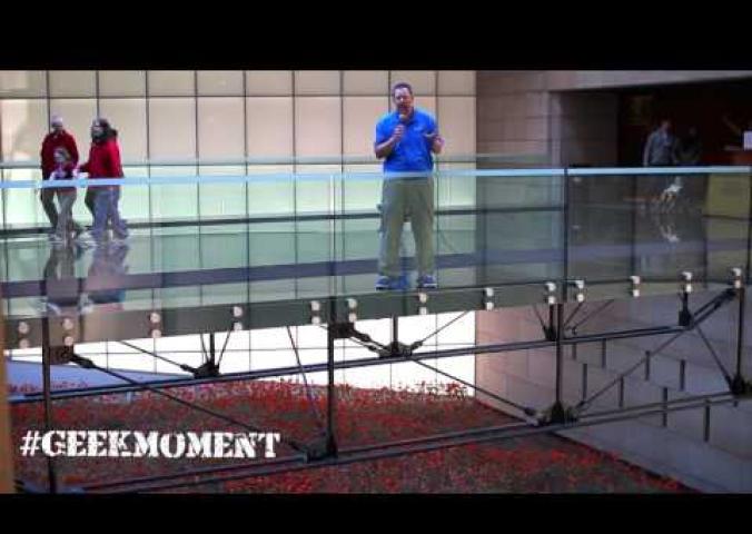 A person speaks above a poppy demonstration representing World War I at the World War I Museum.