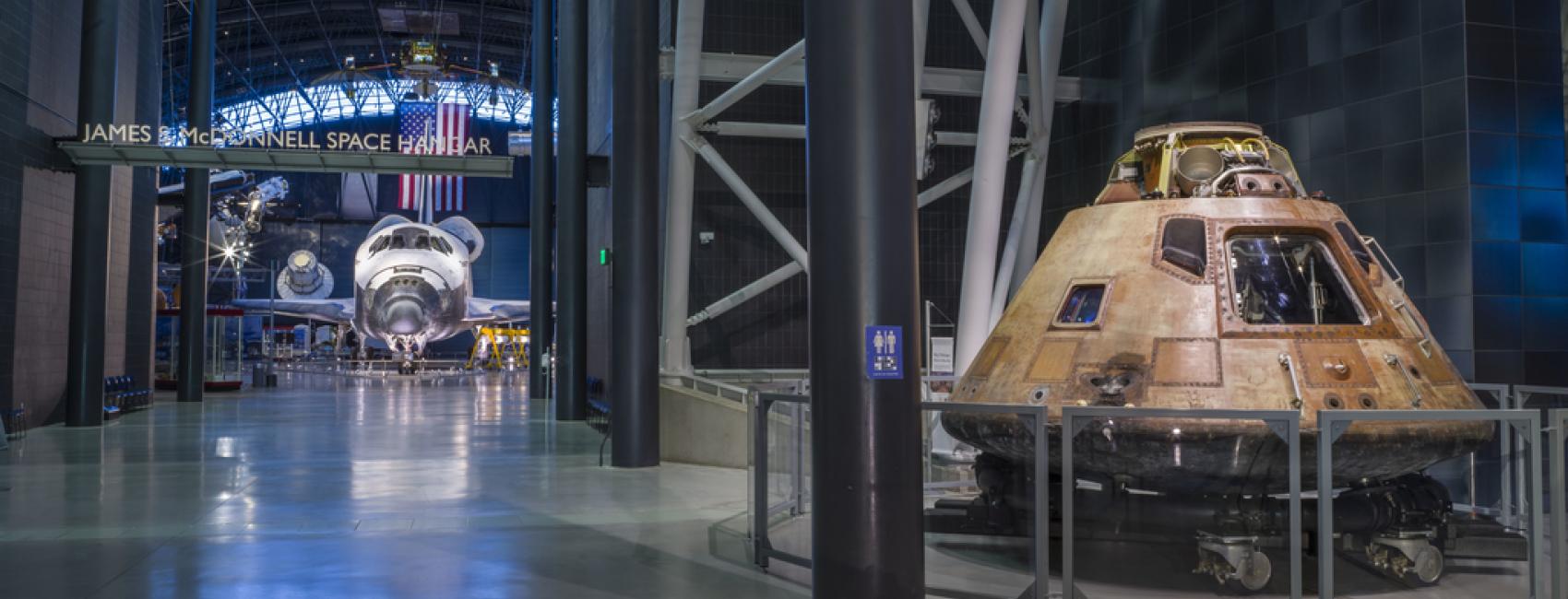 The Space Shuttle Discovery and Apollo 11 command module Columbia are both on display at the Steven F. Udvar-Hazy Center in this photograph.