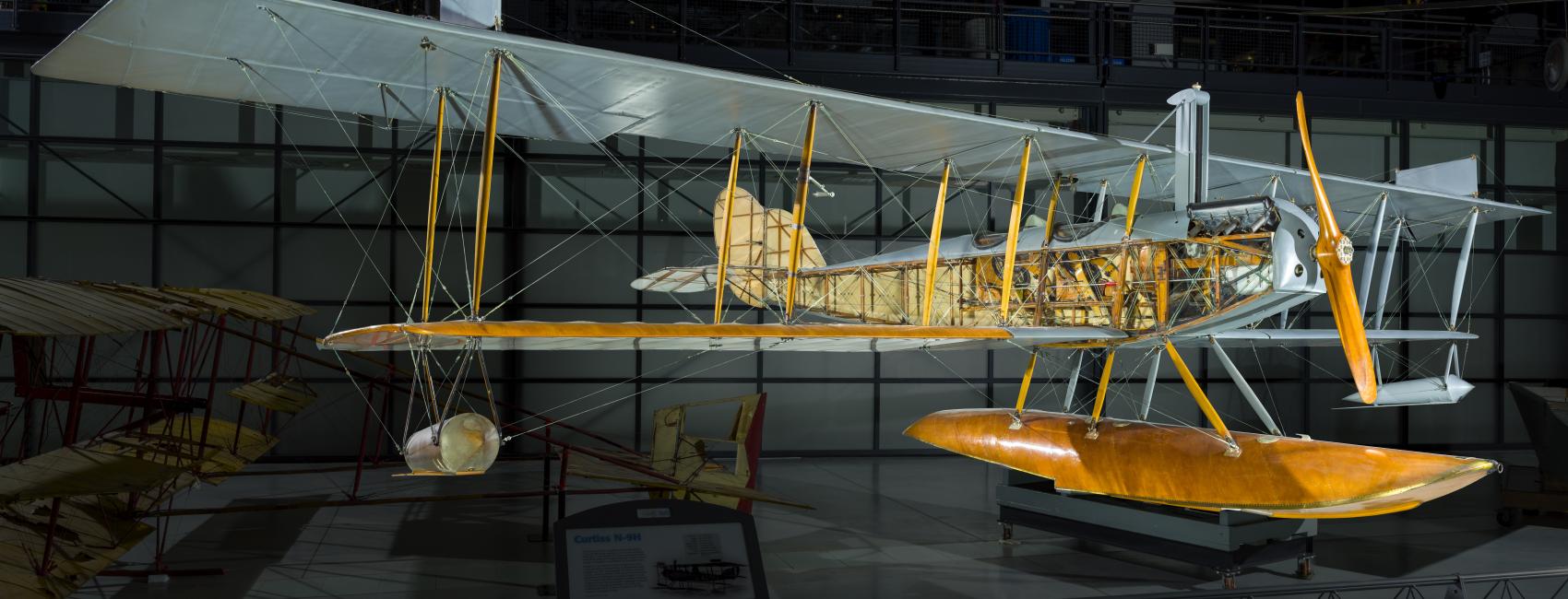 View of the front of a seaplane in a gallery. 