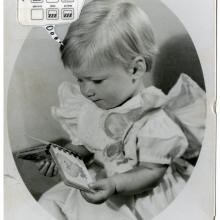 Portrait of Sally Ride as a young child. She is looking at a pocket book. The portrait features a thought bubble caption of technical notes.