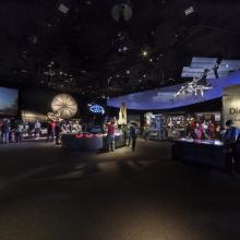 A gallery in the National Air and Space Museum with a live shuttle launch taking place.