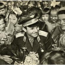 Soviet cosmonaut Yuri Gagarin surrounded by a crowd of children